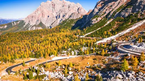 Passo Valparola, Itálie. Pohled na serpentiny v Tyrolsku, Dolomity. Pohled na horu Piz Cunturines (3 064 m) z Passo di Valparola na podzim poblíž Cortiny d'Ampezzo, Belluno v Itálii